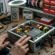 A PC technician inspecting modular cables to pick safe PSU hardware for a desktop build
